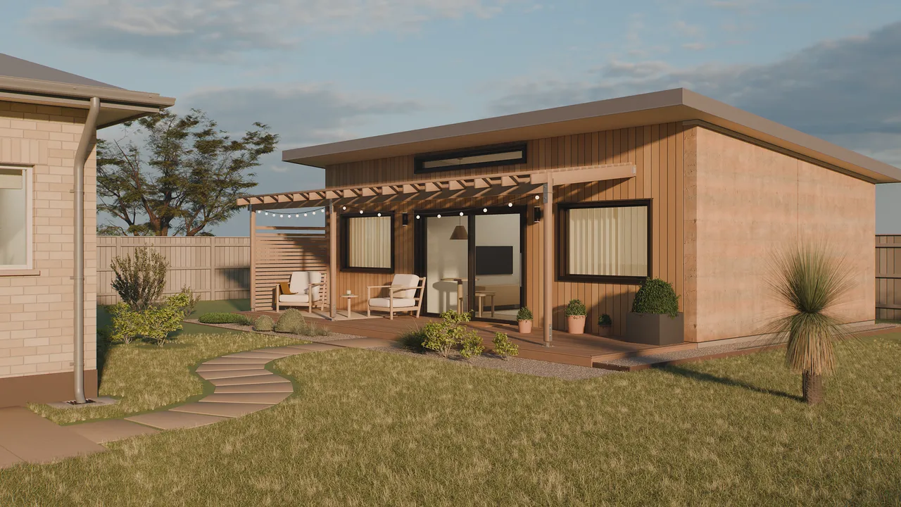 Studio concept render of Seed 60, a 60 square metre backyard home with timber cladding, a rammed earth wall and a covered deck, behind a neighbouring house in Adelaide at golden hour.